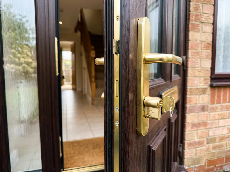 A new brass euro cylinder lock fitted to a uPVC front door